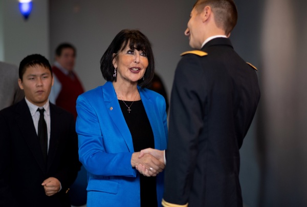 President Mantella shakes the hand of Lt. Jackson Wierenga after he became the first military officer commissioned on GVSU's campus during her tenure.