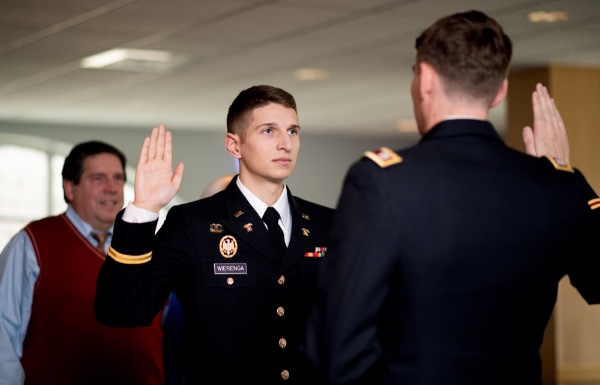 Jackson Wierenga holds his hand up to take an oath to serve his country, administered by his brother, Jeb.