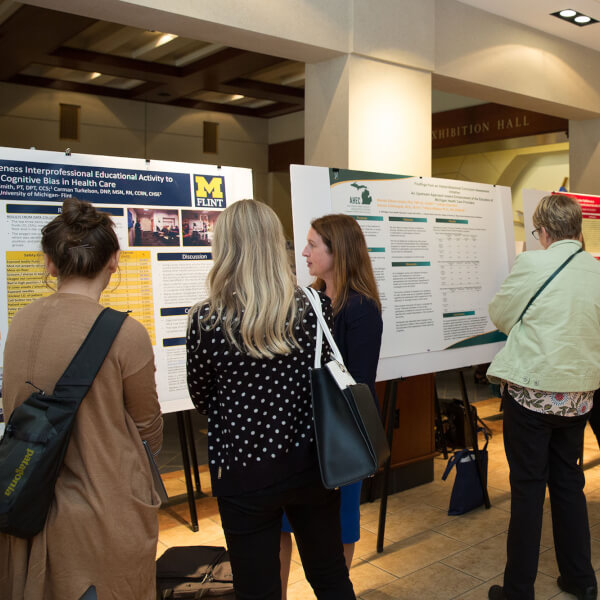groups of people looking at poster presentations