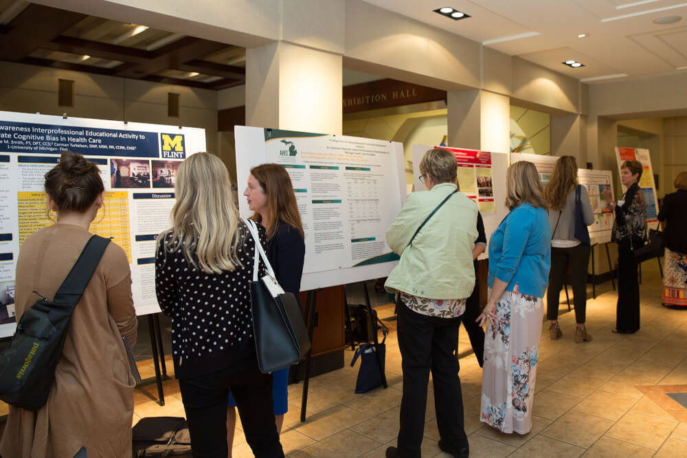 groups of people looking at poster presentations