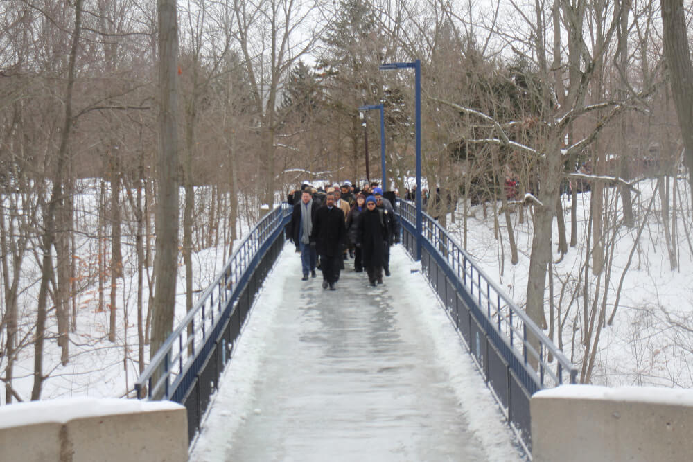 people marching over a bridge