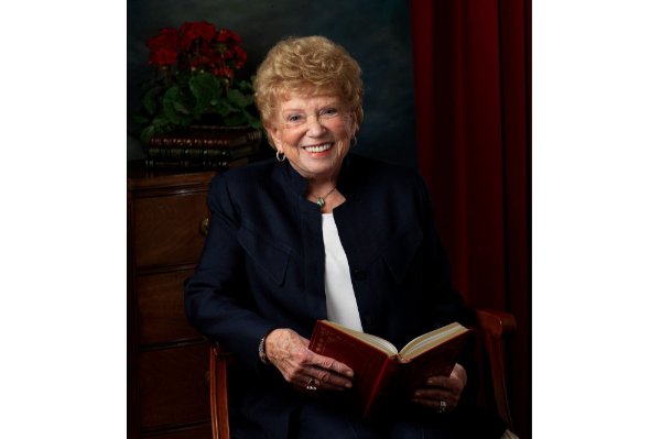portrait of Joyce Wisner holding an open book