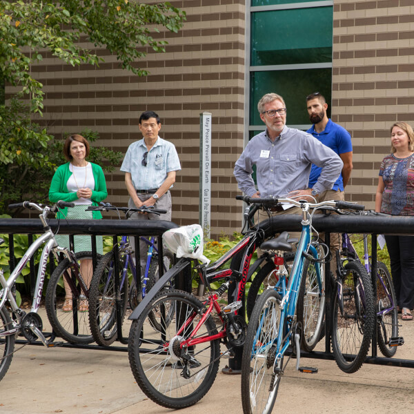 small crowd gathered around peace pole