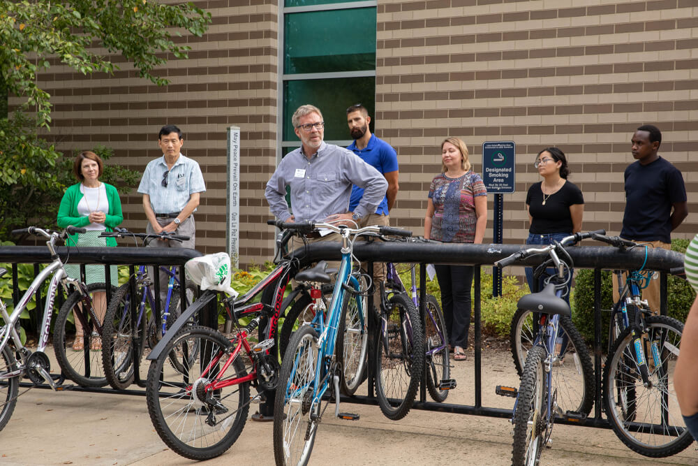 small crowd gathered around peace pole