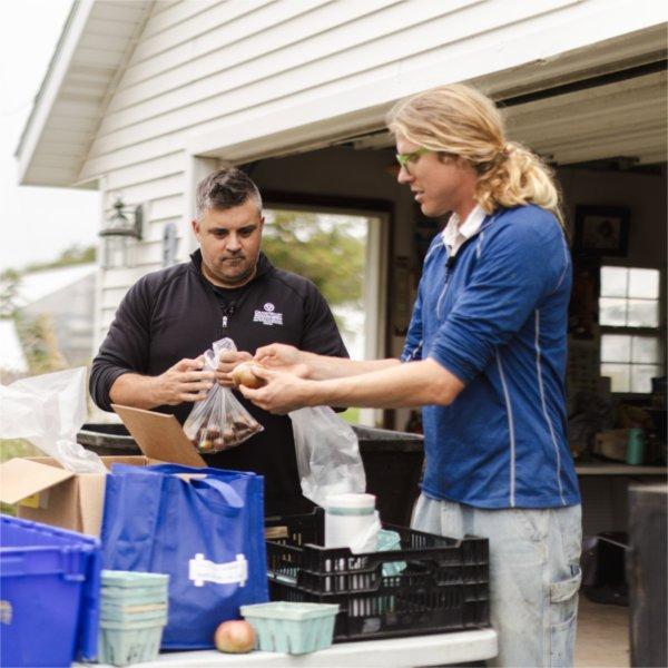 Shane Scherer and Isak Davis sort veggetables at the SAP
