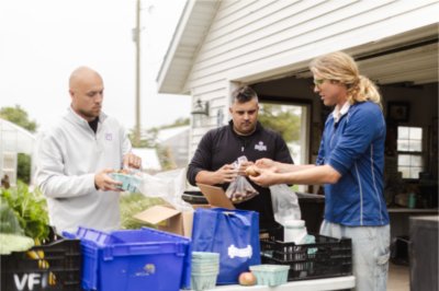 Shane Scherer, Caleb Worpel and Isak Davis sort veggetables at the SAP