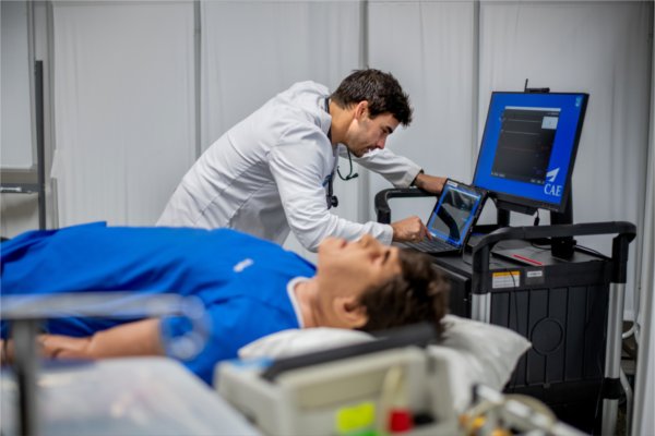Matthew Purtee, graduate physician assistant studies student, demonstrates a high-fidelity patient simulator.