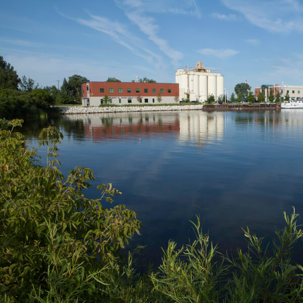 The field station and Lake Michigan Center are shown and reflected in the waters of Muskegon Lake.