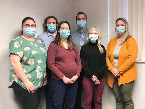 From left to right are Brittany Oehlers, Christopher Laninga, Debra Swoverland, Jay Gillespie, Lara Gavaldon and Lindsey Banktson. All are wearing masks and pictured inside a conference room.