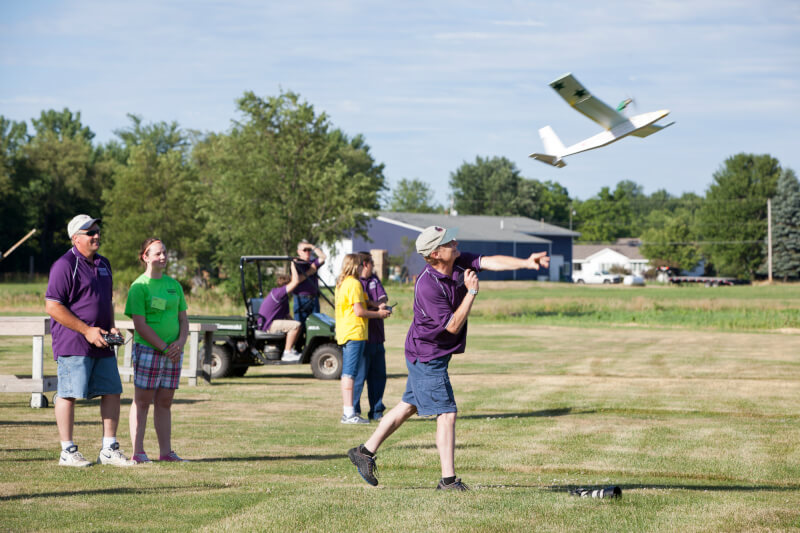 A photos of campers flying their airplanes.