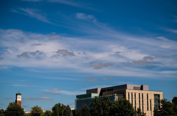 The carillon on the Allendale campus and the library building are set against a blue sky with wispy clouds.