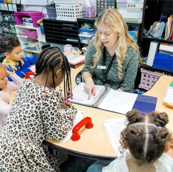 Teacher leads students in a reading exercise.