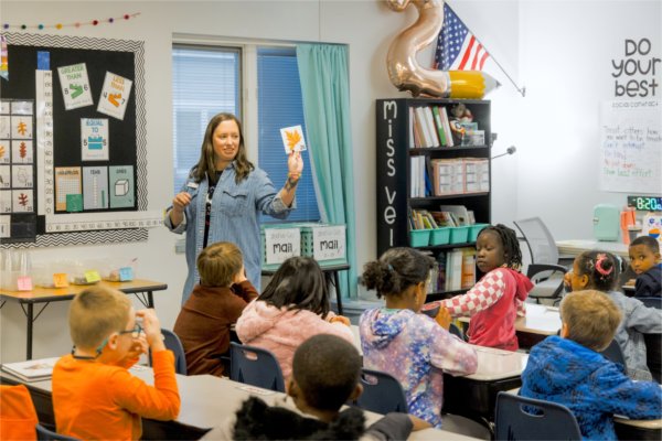 Teacher at Excel Charter Academy leading class in a reading exercise