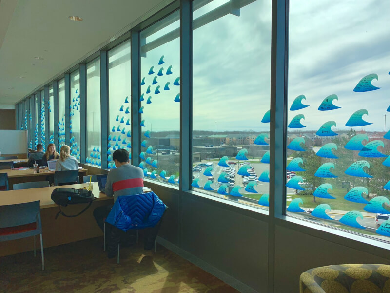 About 1,000 "waves of wishes" are displayed on the library windows, wishing students good luck during finals week.