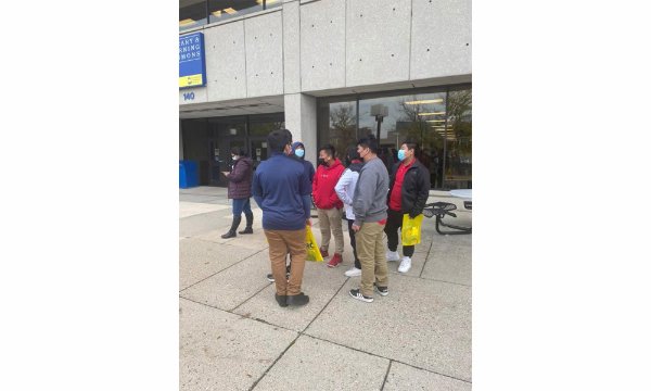 High school students stand outside a GRCC building