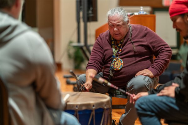 A drum circle performs at an event. 