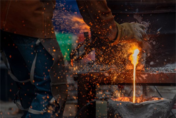 Hot glowing liquid iron being poured from a cupola. 