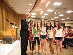 Michigan History Day Regional Coordinator Sean O'Neill, Grand Valley professor of history, congratulates a group of young winners.