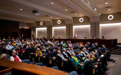 Picture of the faculty awards convocation program and an award cup.