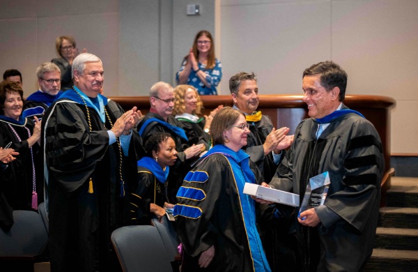Christian Trefftz, professor of computing, receives a standing ovation after accepting the Glenn A. Niemeyer Award during the Faculty Awards Convocation.
