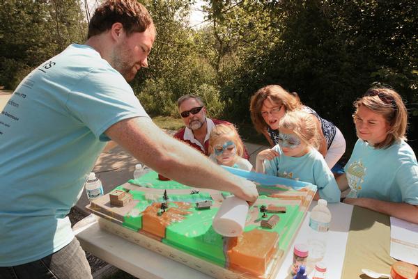 Participants learning what happens after rain falls and flows into streams. Photo by Rex Larsen