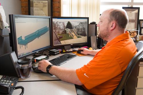Photos by Amanda Pitts <br> Richard Campbell is pictured at his computer with a model of a wheelchair ramp.