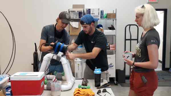 Grand Valley research team attaches an underwater camera to a frame for collecting images.