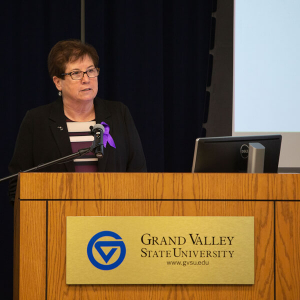 A photo Sue Snyder at the podium.
