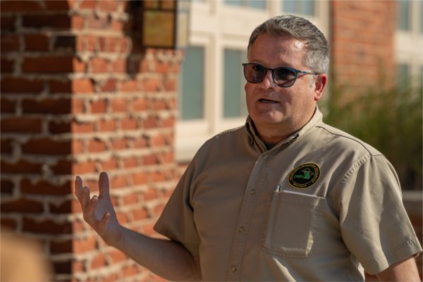 Man talking to visitors about Ludington State Parl