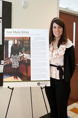 Ann Marie Klotz pictured next to her "Our Stories" poster.