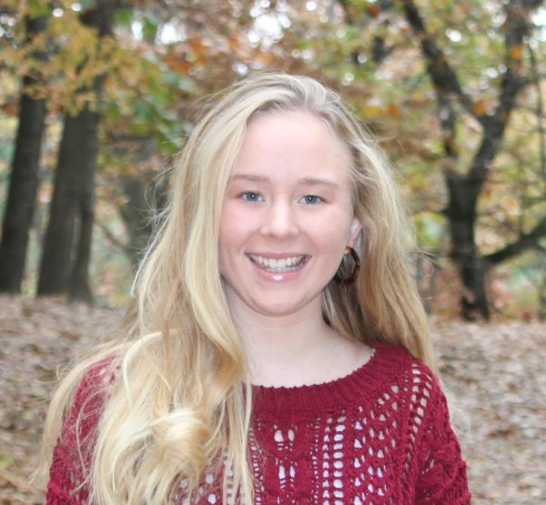 headshot of Christina Vann, outdoors near wooded area