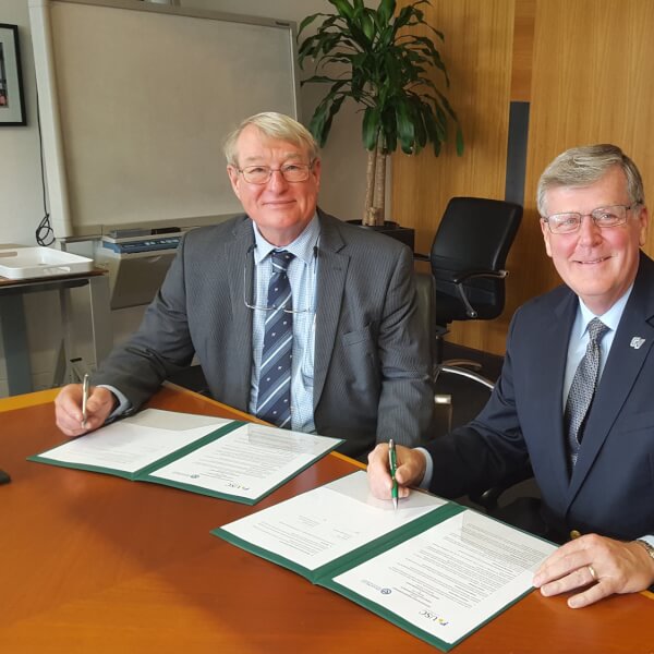President Haas, right, and Greg Hill, vice chancellor of the University of Sunshine Coast (USC) in Australia, signed a new five-year agreement to extend the partnership between the two universities.
