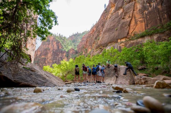 The Water in the West team scales a large rock to take in the view at The Narrows. 