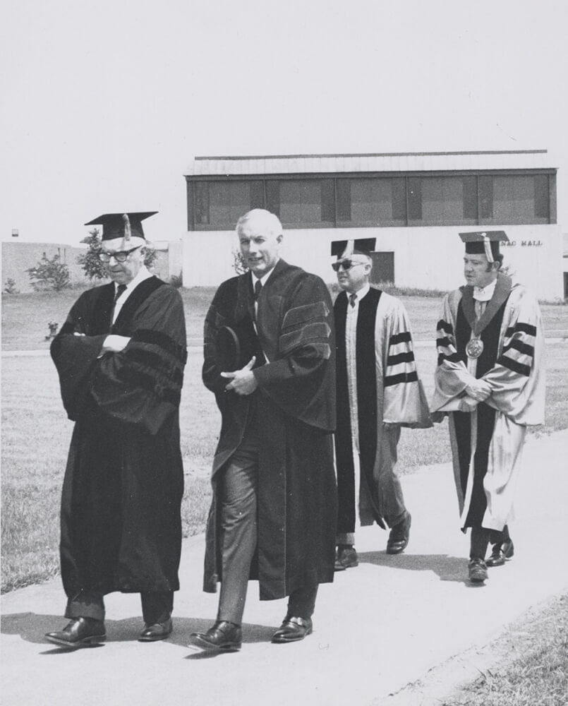 people walking in academic regalia
