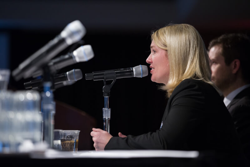 woman speaking into microphone