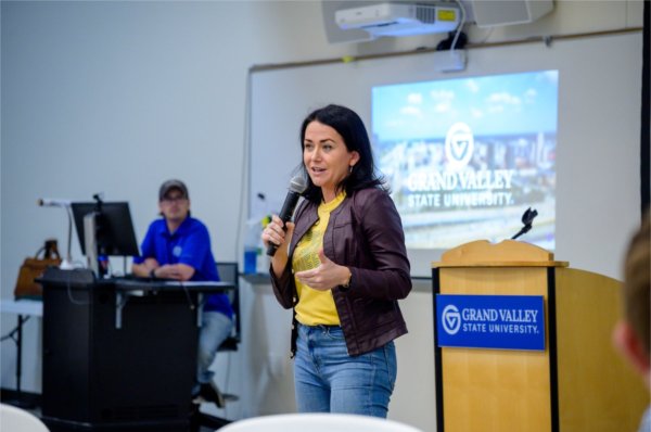 Andria Romkema, senior vice president for business development for The Right Place, speaks in front of a room with a microphone
