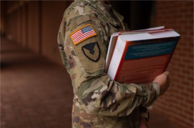 Veteran student holding textbooks
