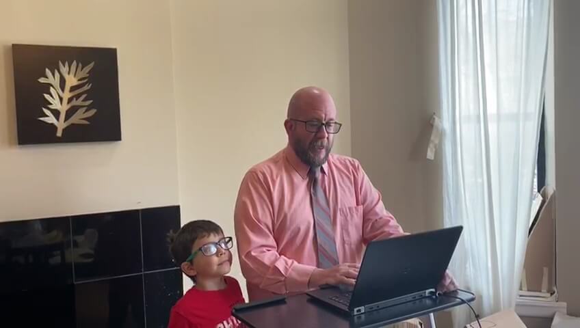 Daniel Michmerhuizen during his video call with former President Obama. Michmerhuizen's 6-year-old son, Mateo, looks on.