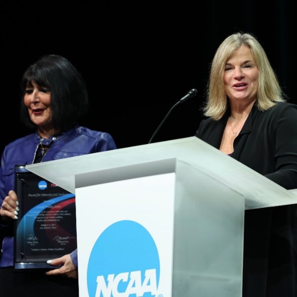 President Philomena V. Mantella and Director of Athletics accept award from NCAA