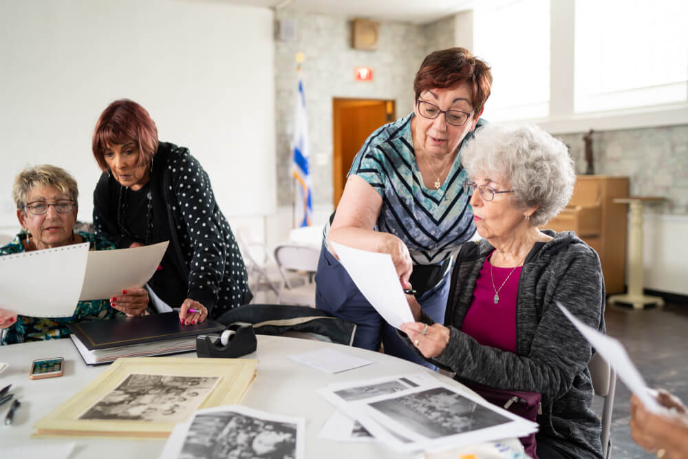 group of older women reviewing photographs