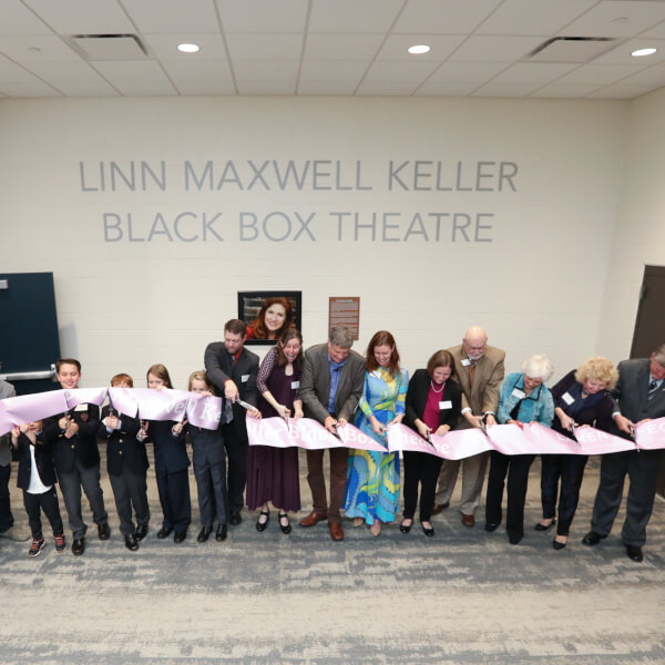 The Keller family, along with members of the Grand Valley community, cutting the dedication ribbon for the Keller Theatre