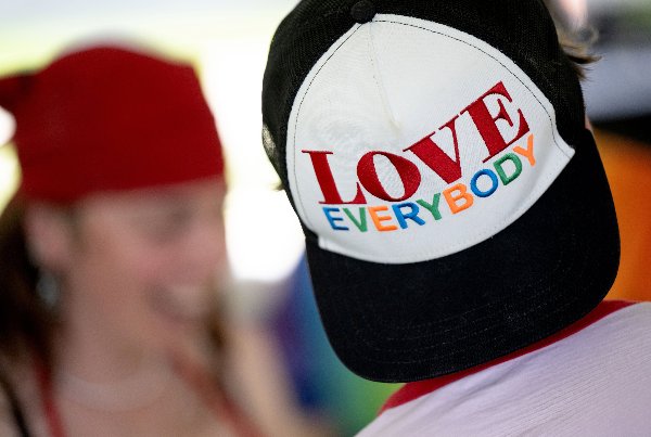 A backwards baseball cap with the words &#8220;love everybody&#8221; in colorful bold letters. 