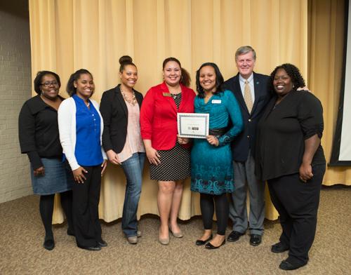 President Thomas J. Haas is pictured with members of Positive Black Women and a scholarship recipient at last year's event.