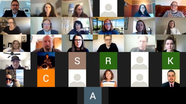 Zoom screenshot of meeting, with many faces in squares and some still photos of people, some initials