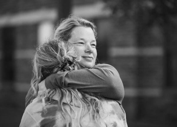 A parent hugs their child during move-in on the Allendale campus