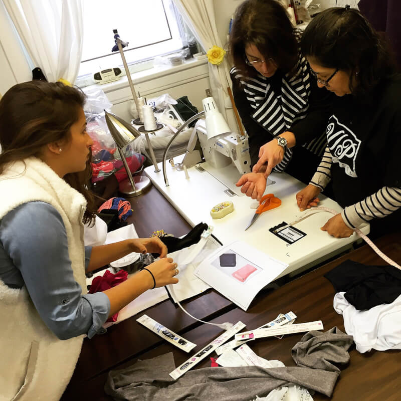 three people at sewing machine