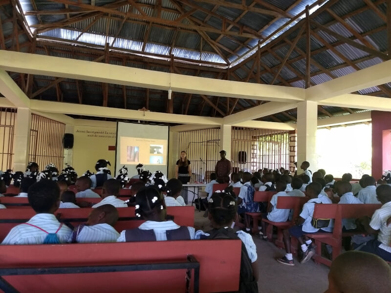 GVSU student Megan DeKeyser teaching students about the human body at a school near Pignon, Haiti.