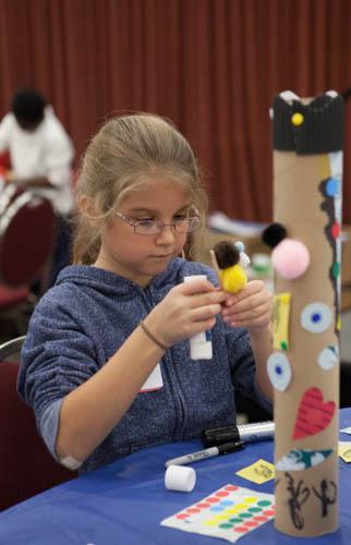 A student from Vanderbilt Charter Academy works on a whispering poetry tube during ArtPrize Education Days 2013.