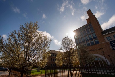 Sun shining behind Seidman College of Business building at Grand Valley State University