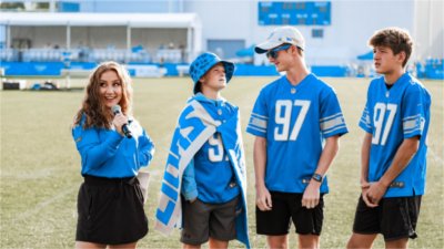 Cristiana Rosa interviewing three Lions fans during Training Camp
